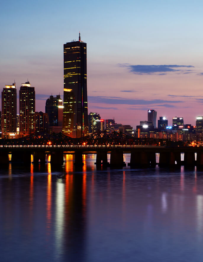 City at night with lights from building reflecting on water