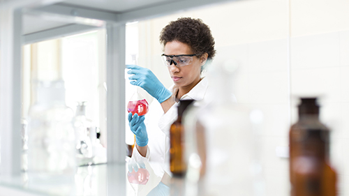 Person in PPE working in a lab