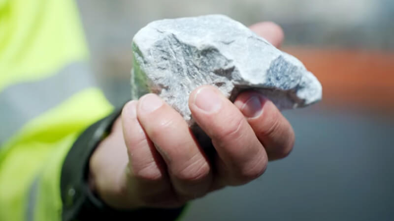 Person showing a chunk of cement