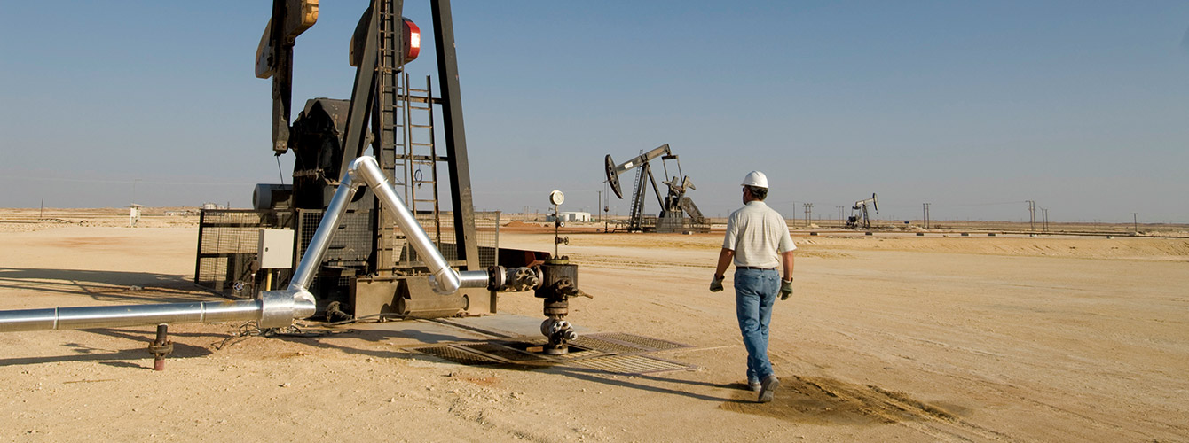 Male worker on oil field in desert